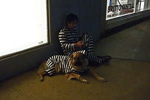 Man with Dog in Jail Costume
